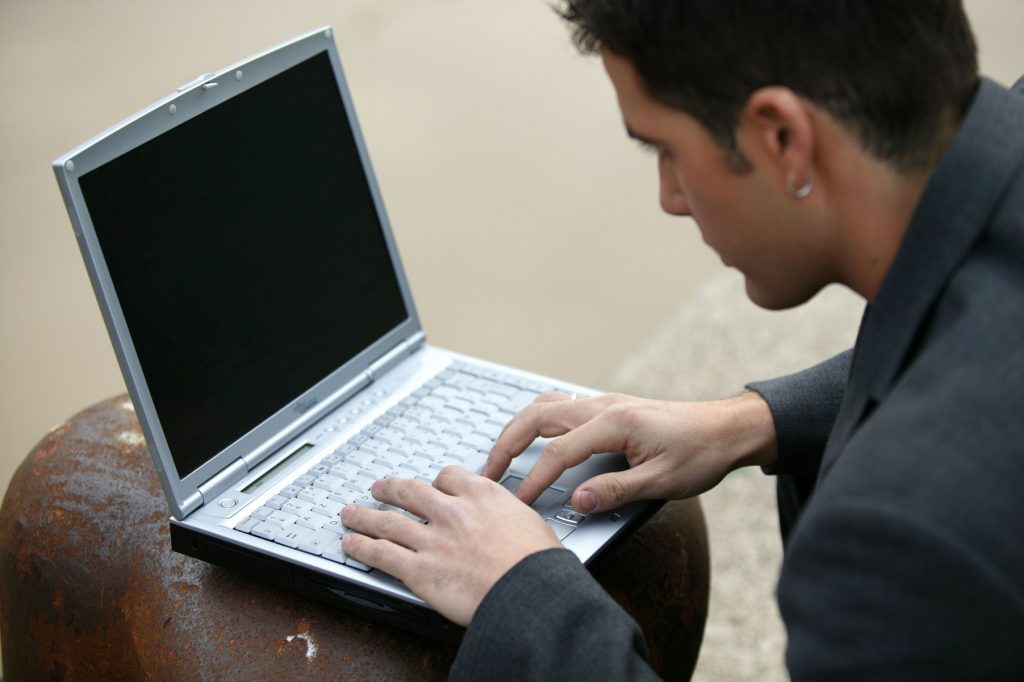 3934835-young-man-typing-on-his-laptop